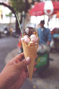 Cropped hand of woman holding ice cream cone