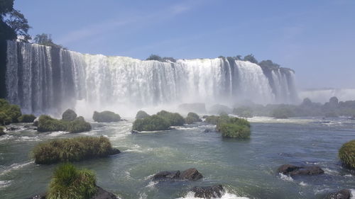 Low angle view of waterfall against sky