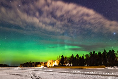 Scenic view of snowcapped mountains against sky at night