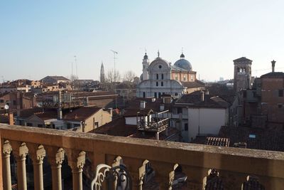 Buildings in city against clear sky