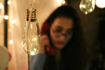 High angle view of lighting equipment with young woman talking on telephone in background