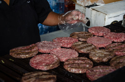 Midsection of person preparing food at market