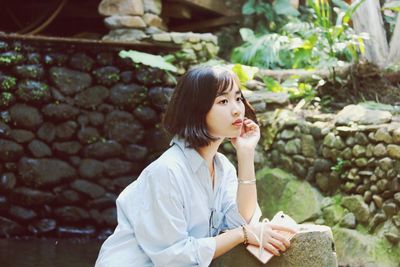 Young woman sitting outdoors