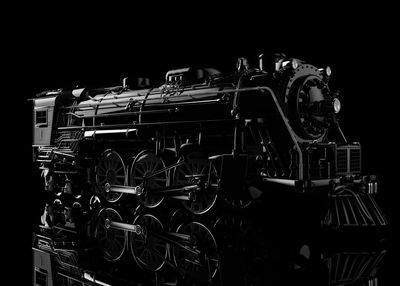 Close-up of machine part against black background