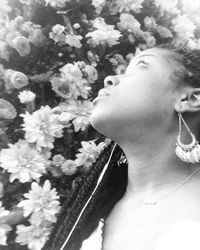 Close-up of young woman with flowers