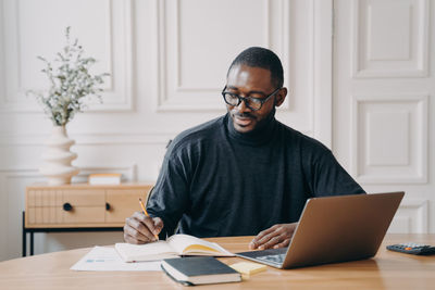 Young man using laptop at office