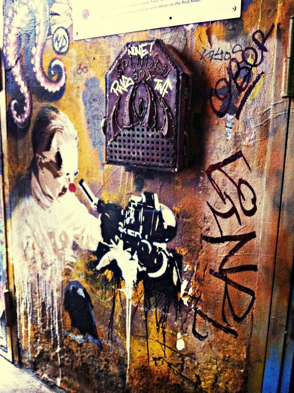 graffiti, art, art and craft, creativity, wall - building feature, indoors, old, built structure, text, architecture, human representation, wall, street art, close-up, damaged, weathered, deterioration, door, vandalism
