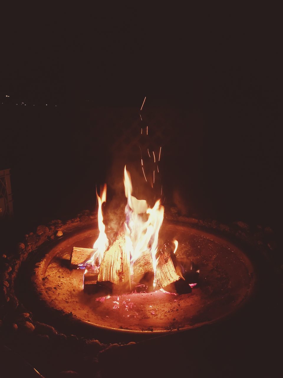 CLOSE-UP OF FIRE BURNING IN THE DARK