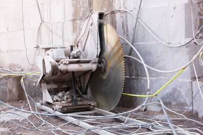 Close-up of electric saw against wall