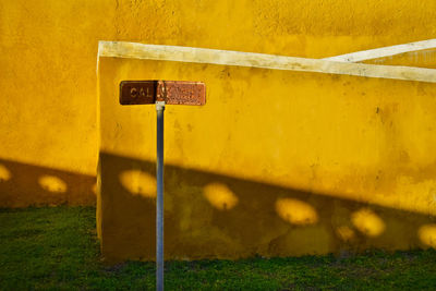 Information sign on yellow wall