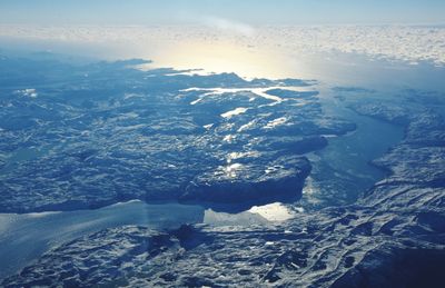 Aerial view of frozen lake against sky during winter