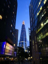 Low angle view of modern buildings against blue sky