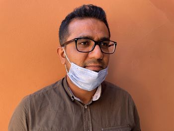 Face closeup of young man with half face covered with mask