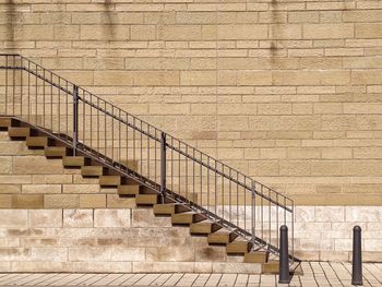 Staircase in front of brick wall