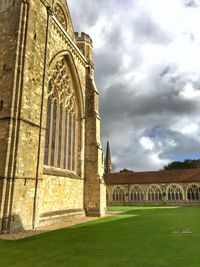 Low angle view of historic building against cloudy sky