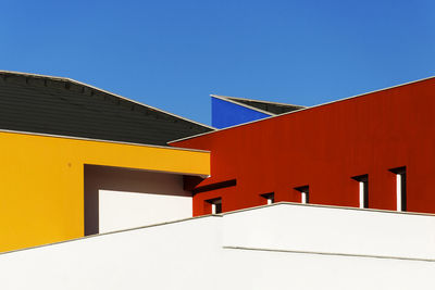 Low angle view of building against clear blue sky