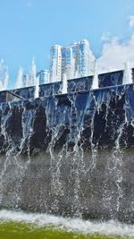 Water splashing in sea against sky