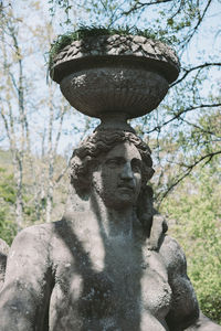 Close-up of statue against trees in park