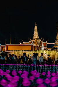 Group of people in temple against building at night