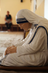 Side view of man and woman sitting on floor