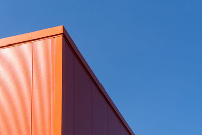 Low angle view of building against clear blue sky