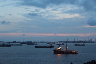 High angle view of ships in sea against cloudy sky