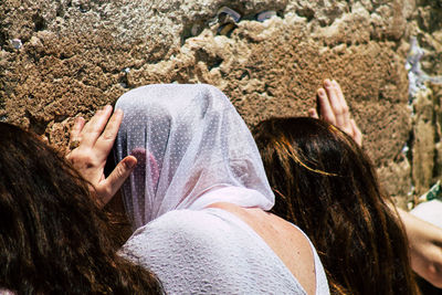 Low section of woman relaxing on rock