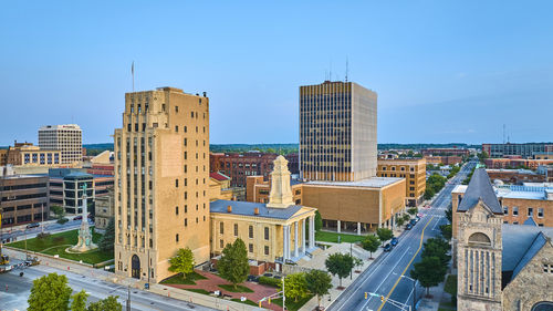 Buildings in city against clear sky