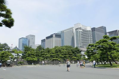 People in city against sky