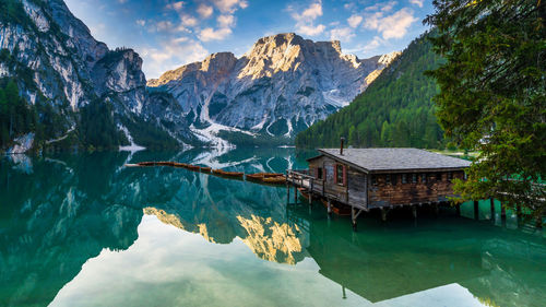 Lake braies in dolomites mountains, boat hut on braies lake with seekofel mount on background