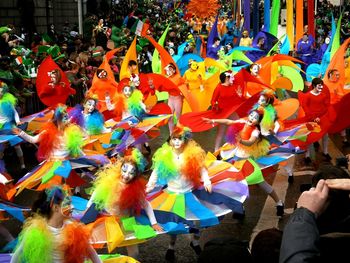 Low angle view of people on multi colored umbrellas