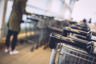 Close-up of cropped shopping trolley