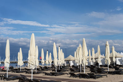 Parasols at beach against sky