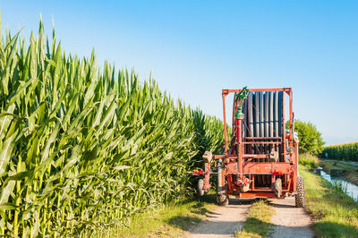 Agricultural machinery by crops on field