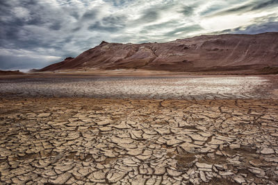 Scenic view of dry land against sky