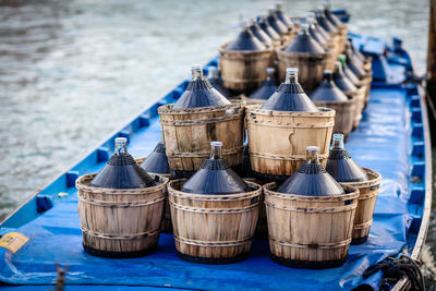 Close-up of barrels on boat in sea