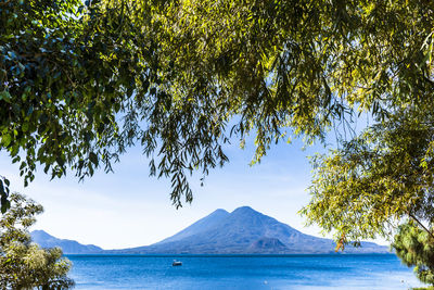 Scenic view of sea and mountains against sky