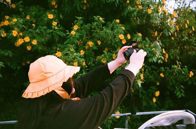 Midsection of woman holding umbrella