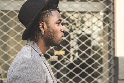 Portrait of young man looking away outdoors