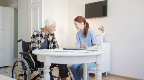 Senior man talking to nurse