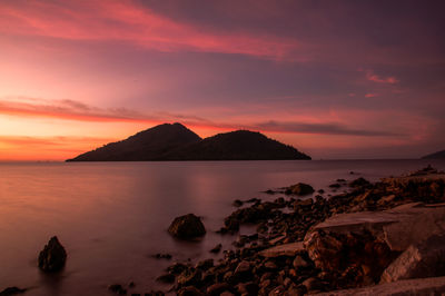 Scenic view of sea against orange sky