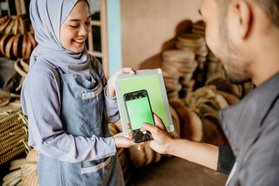 Midsection of woman using mobile phone