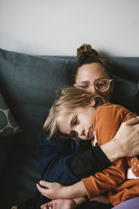 Mother hugging daughter