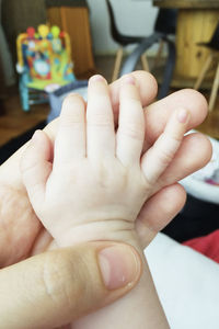 Close-up of hands holding baby hand