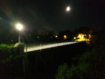 Illuminated lights against sky at night