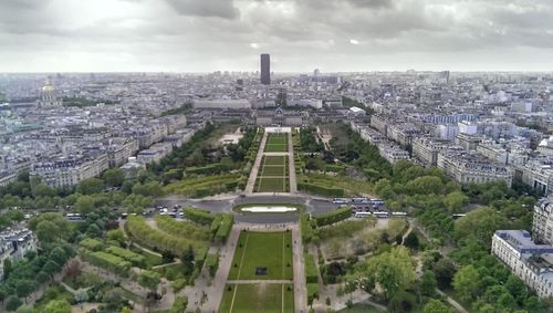 Aerial view of city against cloudy sky