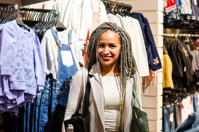 Peruvian woman smiling with braids shopping for clothes