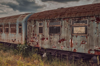 Abandoned train by plants