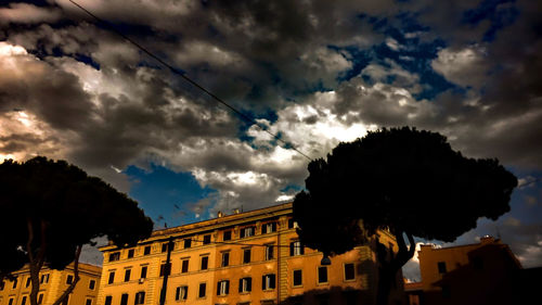 Low angle view of building against cloudy sky
