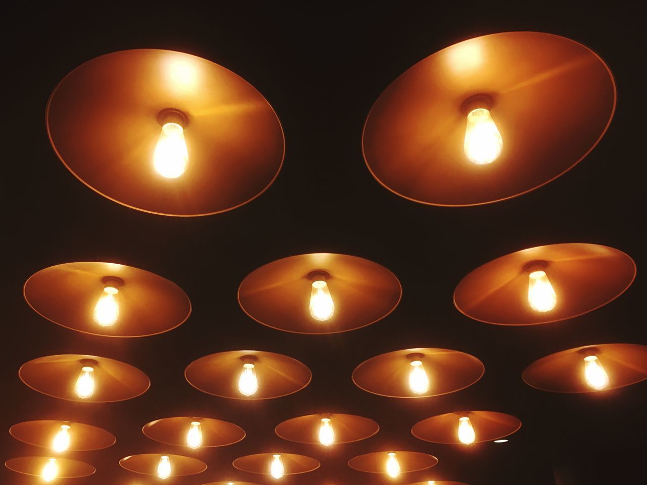 CLOSE-UP OF ILLUMINATED TEA LIGHT CANDLE